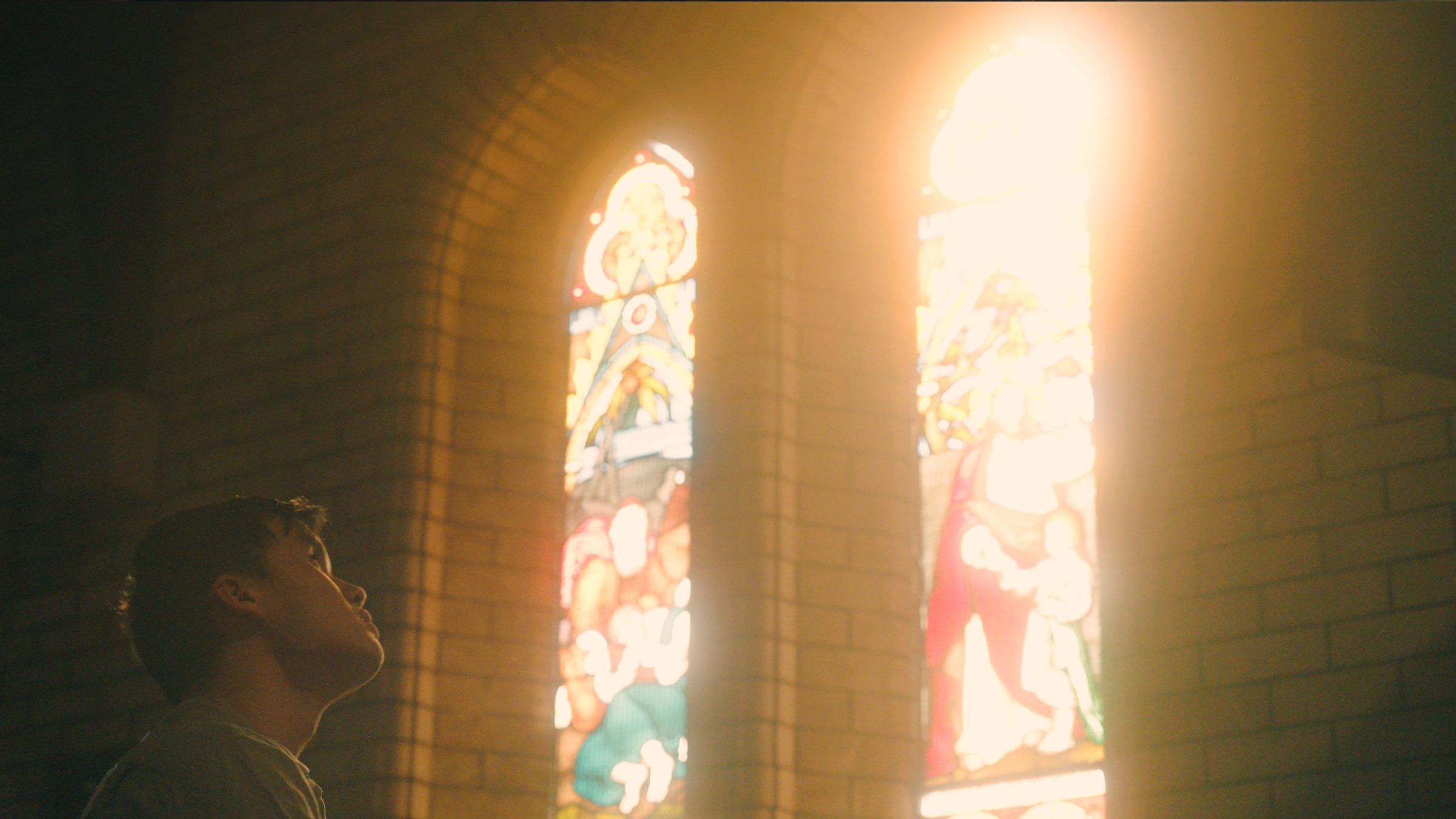 Looking up at light pouring through stained glass windows
