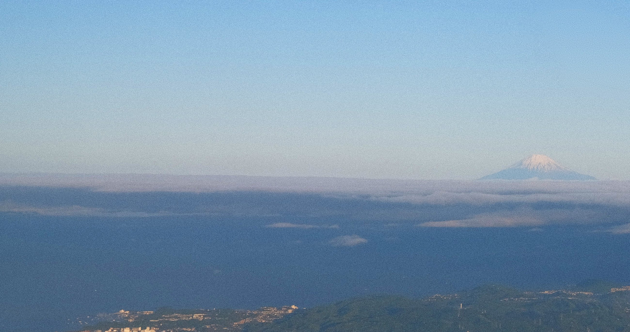 Mount Fuji rising above the clouds, seen from the sky