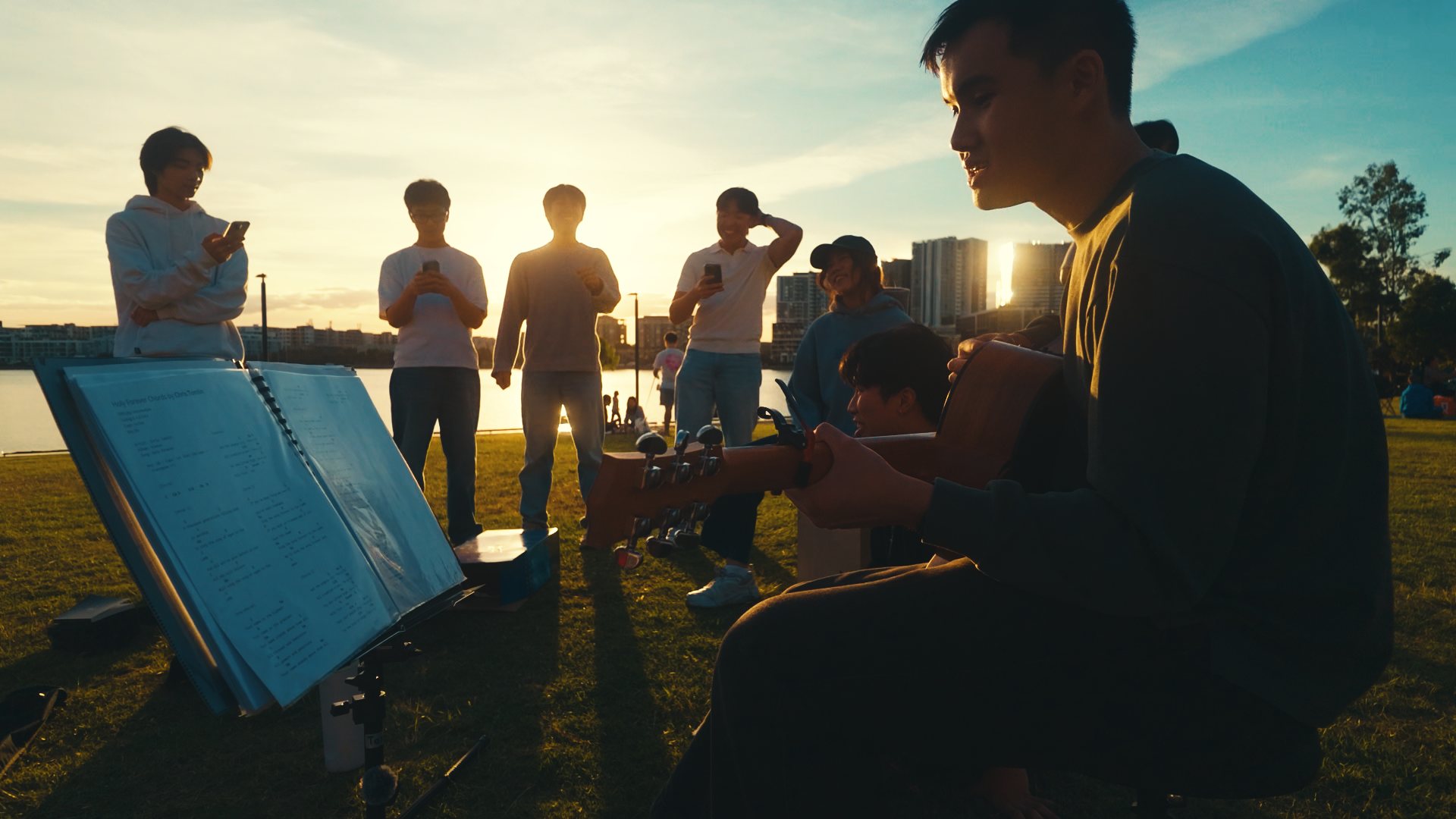 Leading songs together outdoors with a guitar and music stand